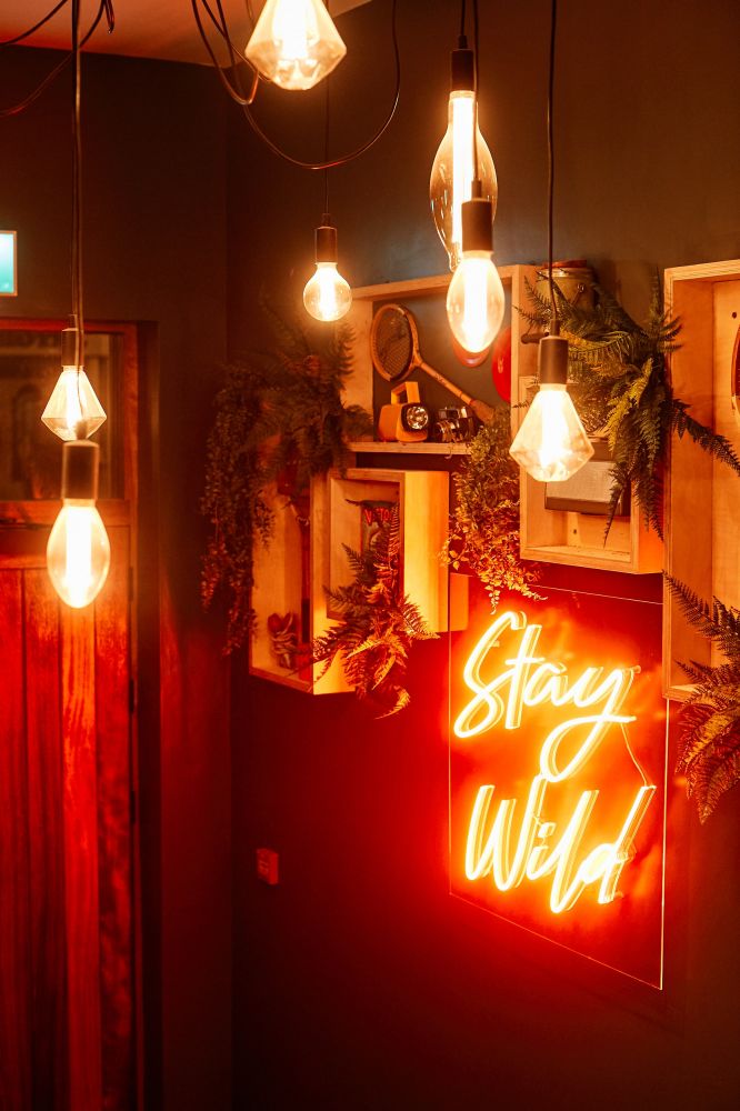 Hotel entry hallway with neon sign