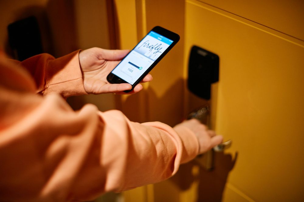 Hotel key on phone being used to open bedroom door